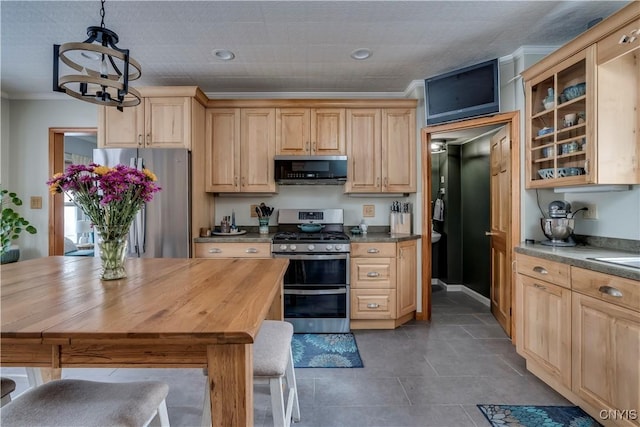 kitchen with glass insert cabinets, appliances with stainless steel finishes, ornamental molding, an inviting chandelier, and light brown cabinetry