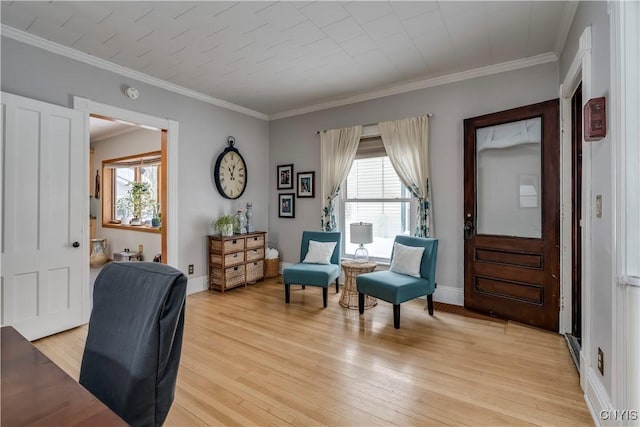 living area featuring light wood-style floors, a wealth of natural light, and crown molding