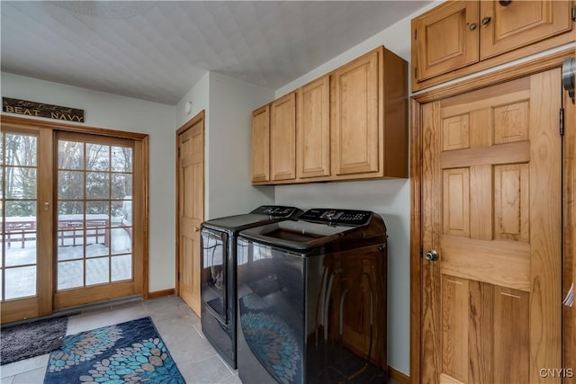 laundry area featuring cabinet space, light tile patterned flooring, baseboards, and independent washer and dryer