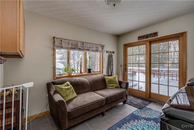 living area with tile patterned flooring and baseboards