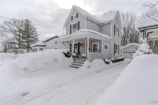 view of front of house with a garage, a porch, and an outdoor structure