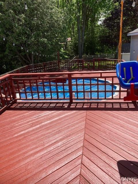 view of pool with a pool and a deck