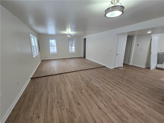 interior space with baseboards and wood finished floors