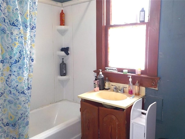 full bath with curtained shower, a tub to relax in, and vanity