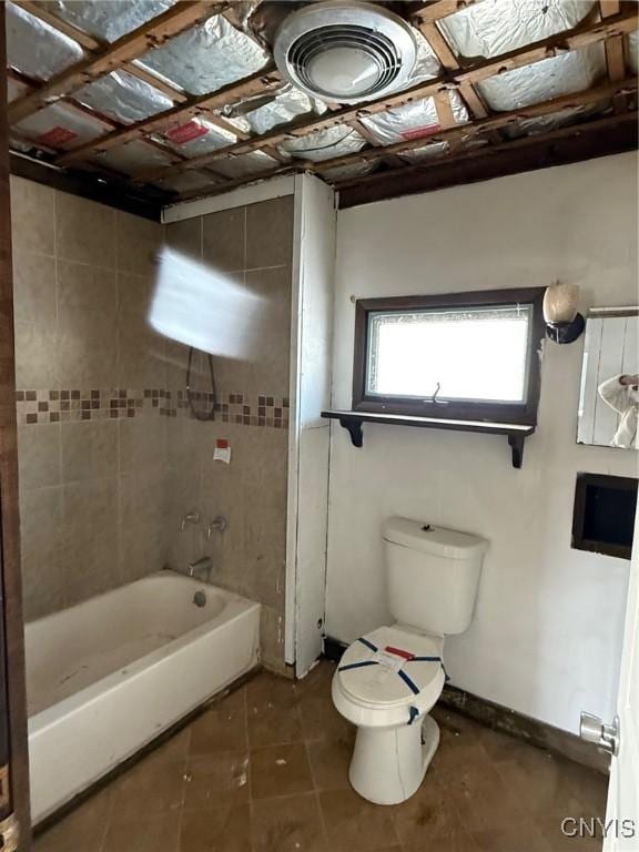 bathroom featuring toilet, visible vents, baseboards,  shower combination, and tile patterned floors