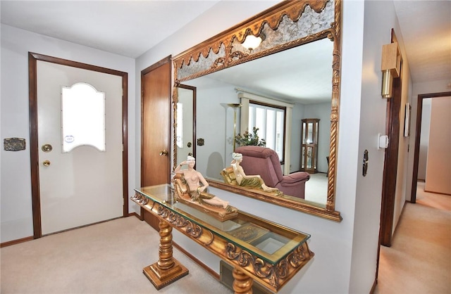 entryway with light colored carpet