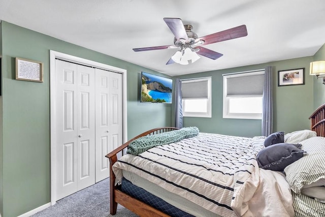 bedroom featuring carpet floors, ceiling fan, baseboards, and a closet