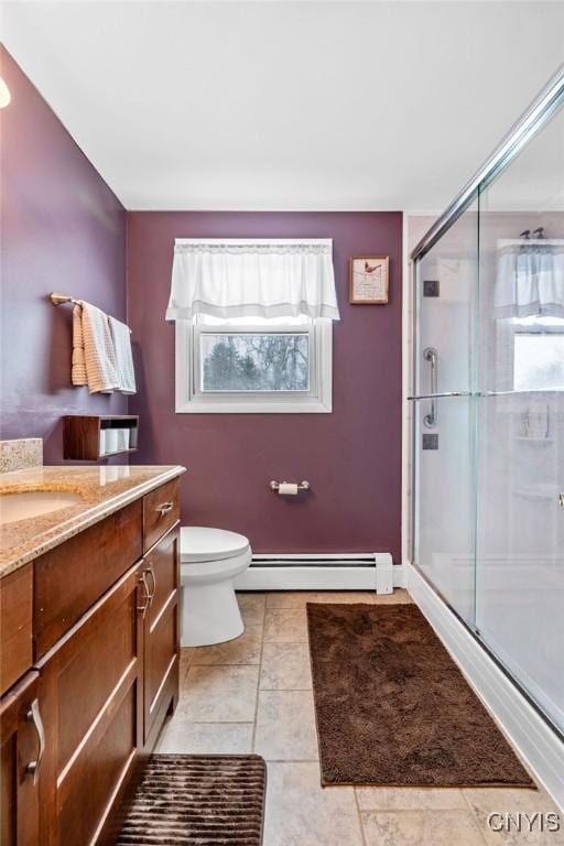 bathroom with toilet, a baseboard radiator, vanity, and a shower stall