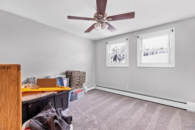 miscellaneous room featuring ceiling fan, a baseboard heating unit, and carpet flooring