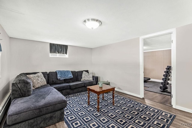 living room with a baseboard radiator, baseboards, and wood finished floors