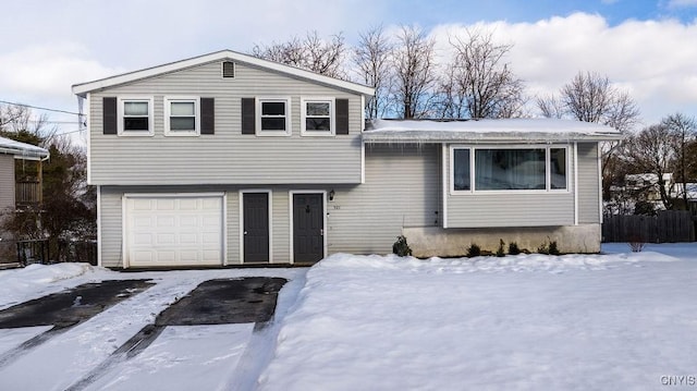 view of front of house with an attached garage and fence