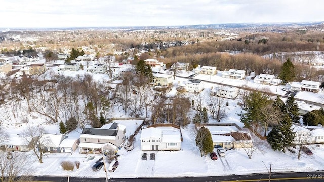 snowy aerial view with a residential view