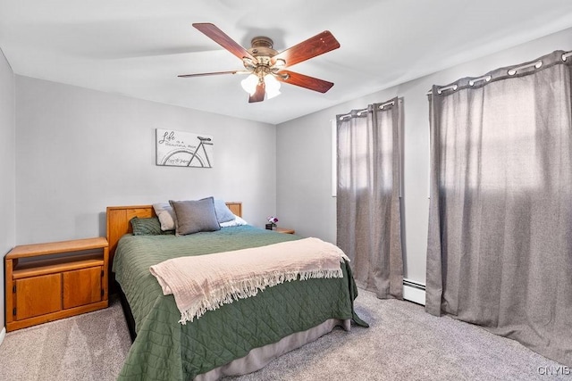 bedroom with a baseboard radiator, carpet, and a ceiling fan