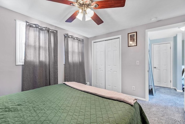 carpeted bedroom featuring a ceiling fan, baseboards, and a closet