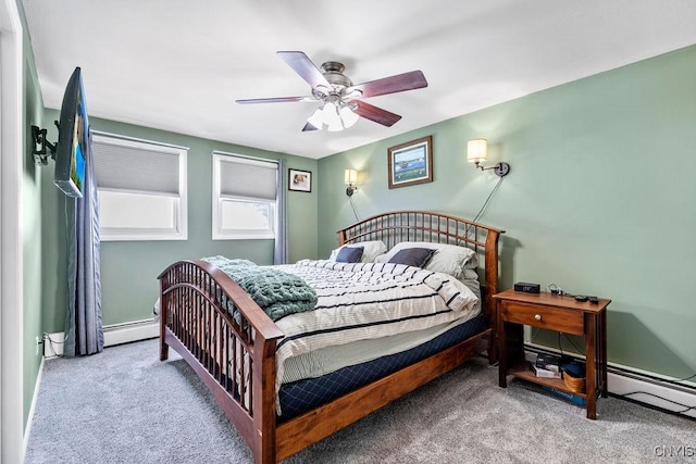 bedroom featuring a baseboard heating unit, carpet, and a ceiling fan