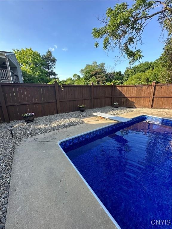 view of pool featuring a patio area, a fenced backyard, and a fenced in pool