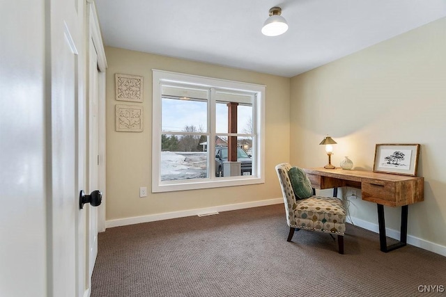 office with baseboards and dark colored carpet