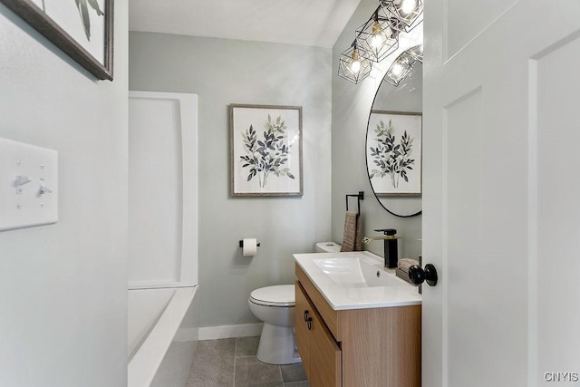 bathroom featuring a washtub, toilet, vanity, baseboards, and tile patterned floors