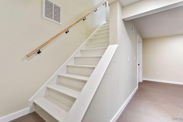 staircase featuring carpet, visible vents, and baseboards