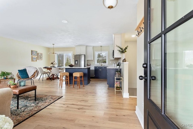 entrance foyer featuring light wood-type flooring and baseboards