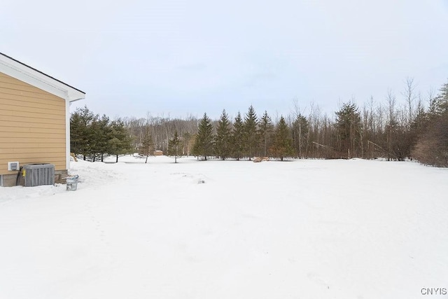 snowy yard featuring central AC unit