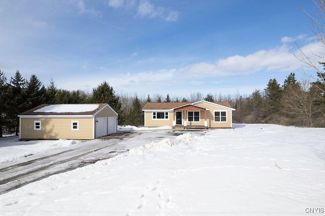 view of front of property with a detached garage and an outdoor structure