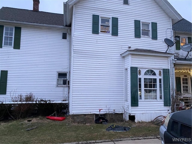 view of property exterior featuring a chimney