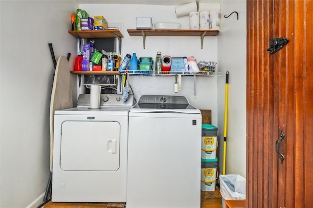 laundry area featuring baseboards, laundry area, and washer and dryer