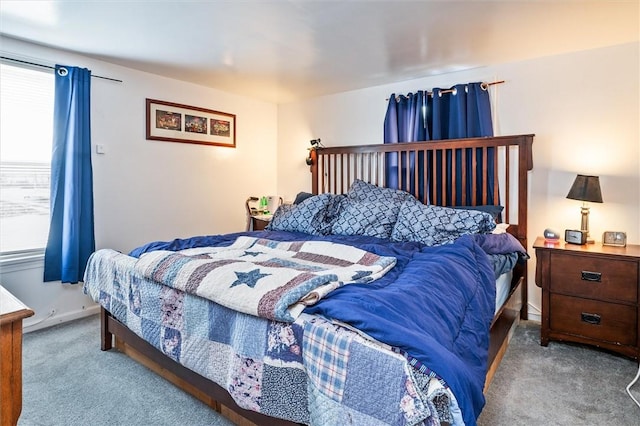 bedroom featuring carpet and baseboards