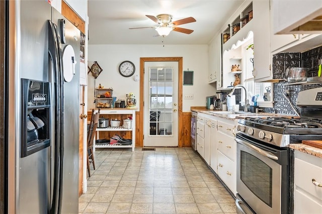 kitchen featuring a sink, white cabinetry, light countertops, appliances with stainless steel finishes, and open shelves