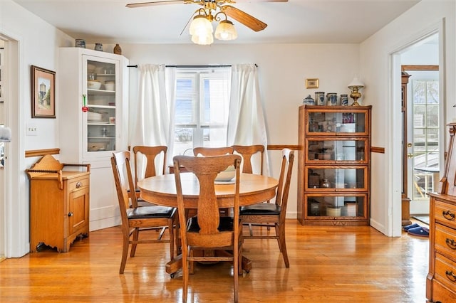 dining area featuring a ceiling fan and light wood-style floors