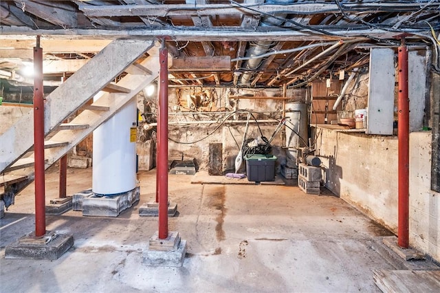 unfinished basement featuring water heater and gas water heater