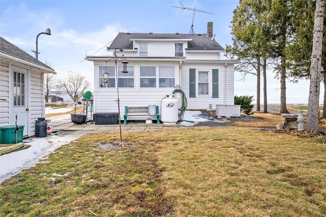 rear view of house with a yard