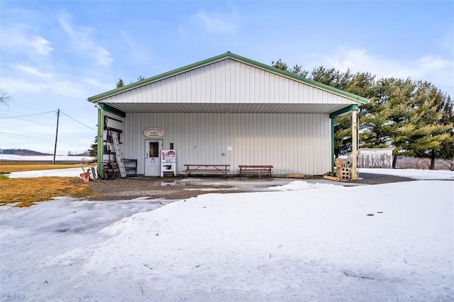 exterior space with a garage, an outbuilding, and a carport