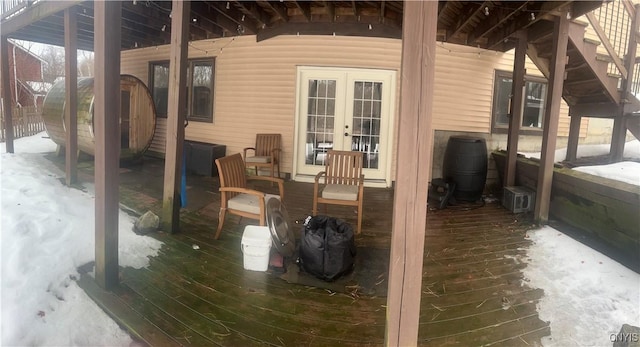 deck with an outbuilding, french doors, and a shed