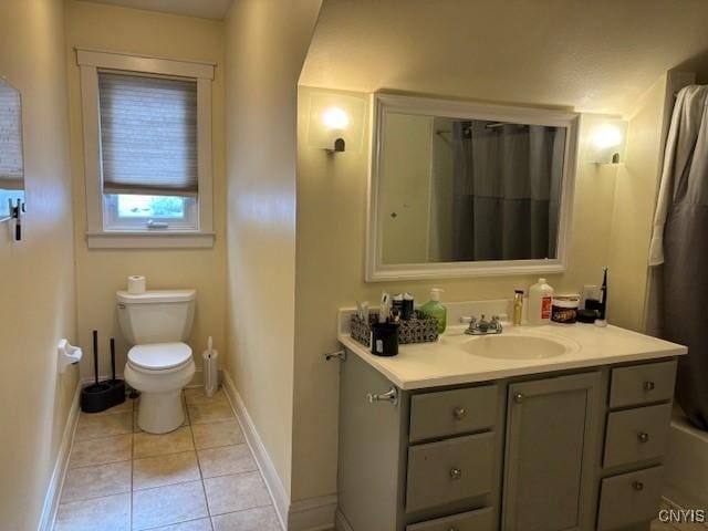 bathroom with baseboards, toilet, tile patterned floors, curtained shower, and vanity