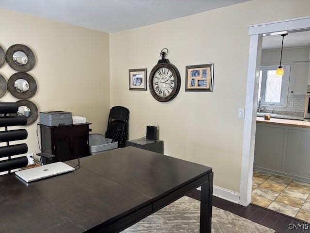 home office featuring baseboards and wood finished floors