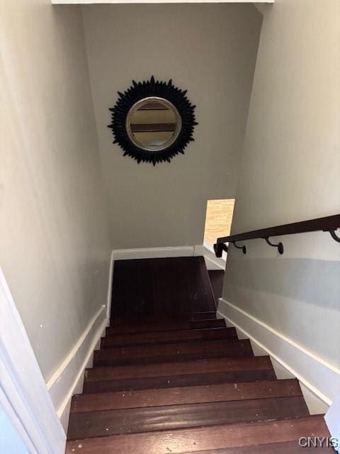 staircase with wood finished floors and baseboards