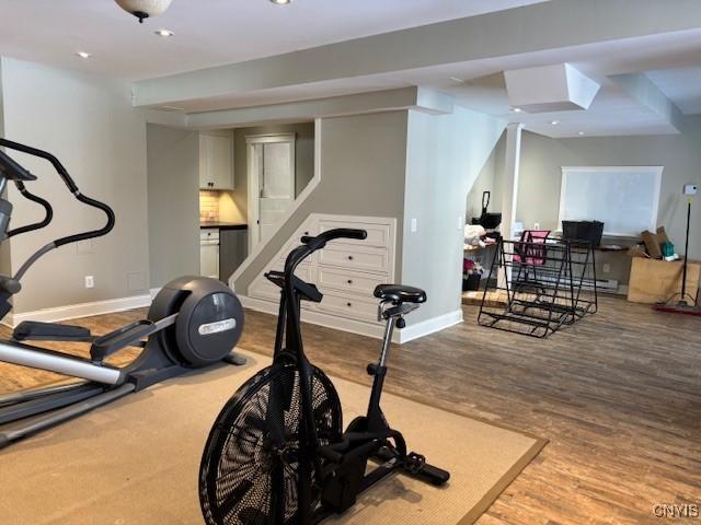 workout room featuring baseboards, wood finished floors, and recessed lighting