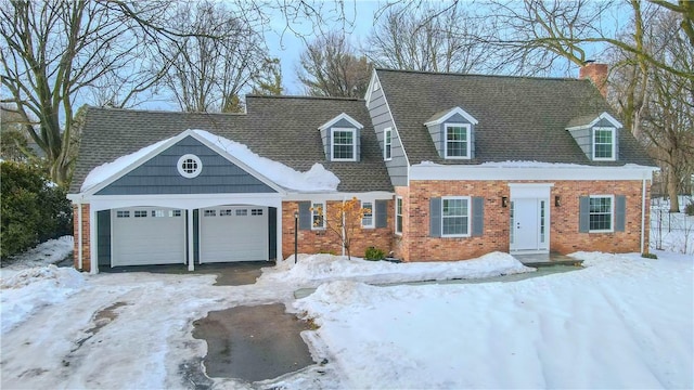 cape cod house featuring a shingled roof, brick siding, driveway, and an attached garage