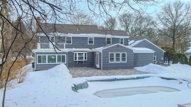 exterior space with a garage and a chimney