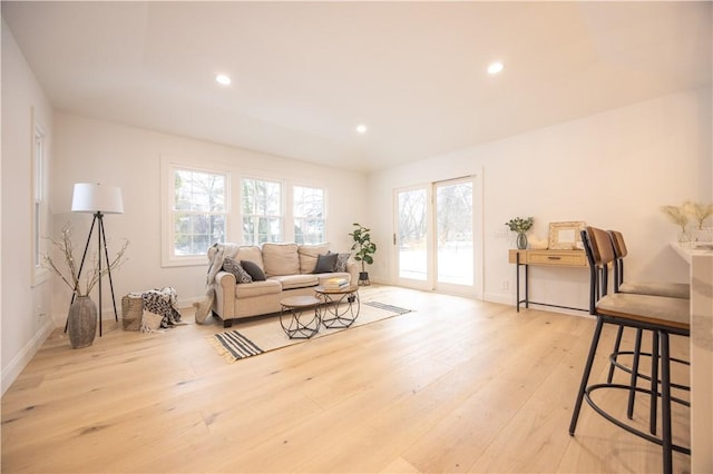 living area featuring a healthy amount of sunlight, light wood-style floors, and recessed lighting