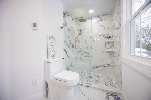 bathroom with marble finish floor, a marble finish shower, and toilet