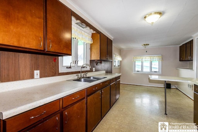 kitchen featuring light countertops, a sink, and light floors