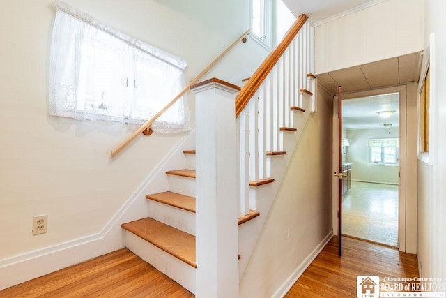 stairs featuring baseboards and wood finished floors