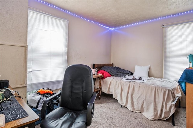 bedroom featuring carpet floors and a textured ceiling