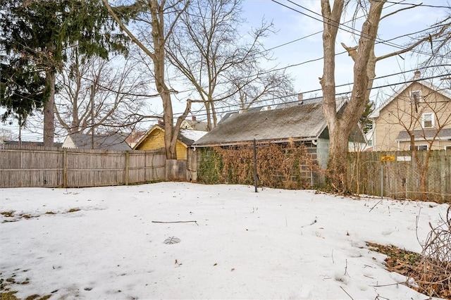 yard layered in snow with fence