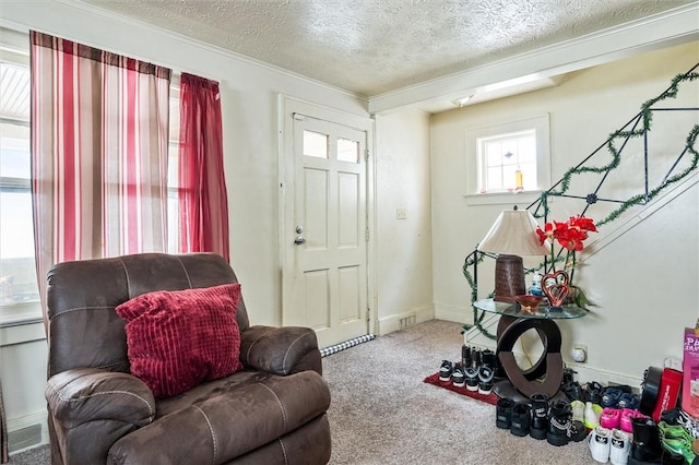 interior space featuring baseboards, a textured ceiling, visible vents, and carpet flooring