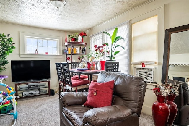 carpeted living area featuring a healthy amount of sunlight, cooling unit, and a textured ceiling