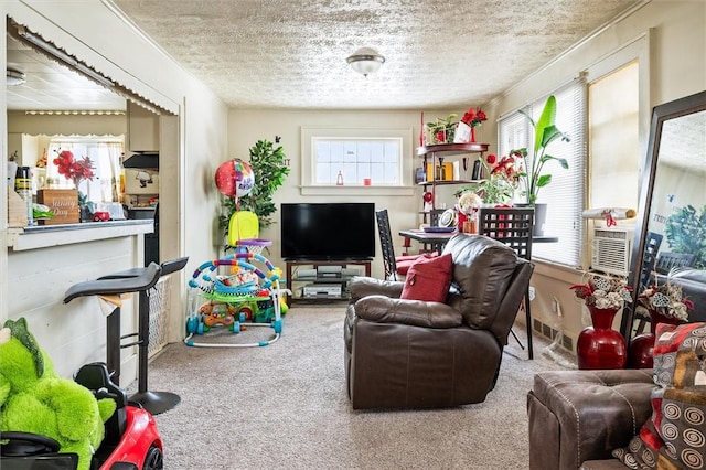 living room with carpet floors, cooling unit, and a textured ceiling